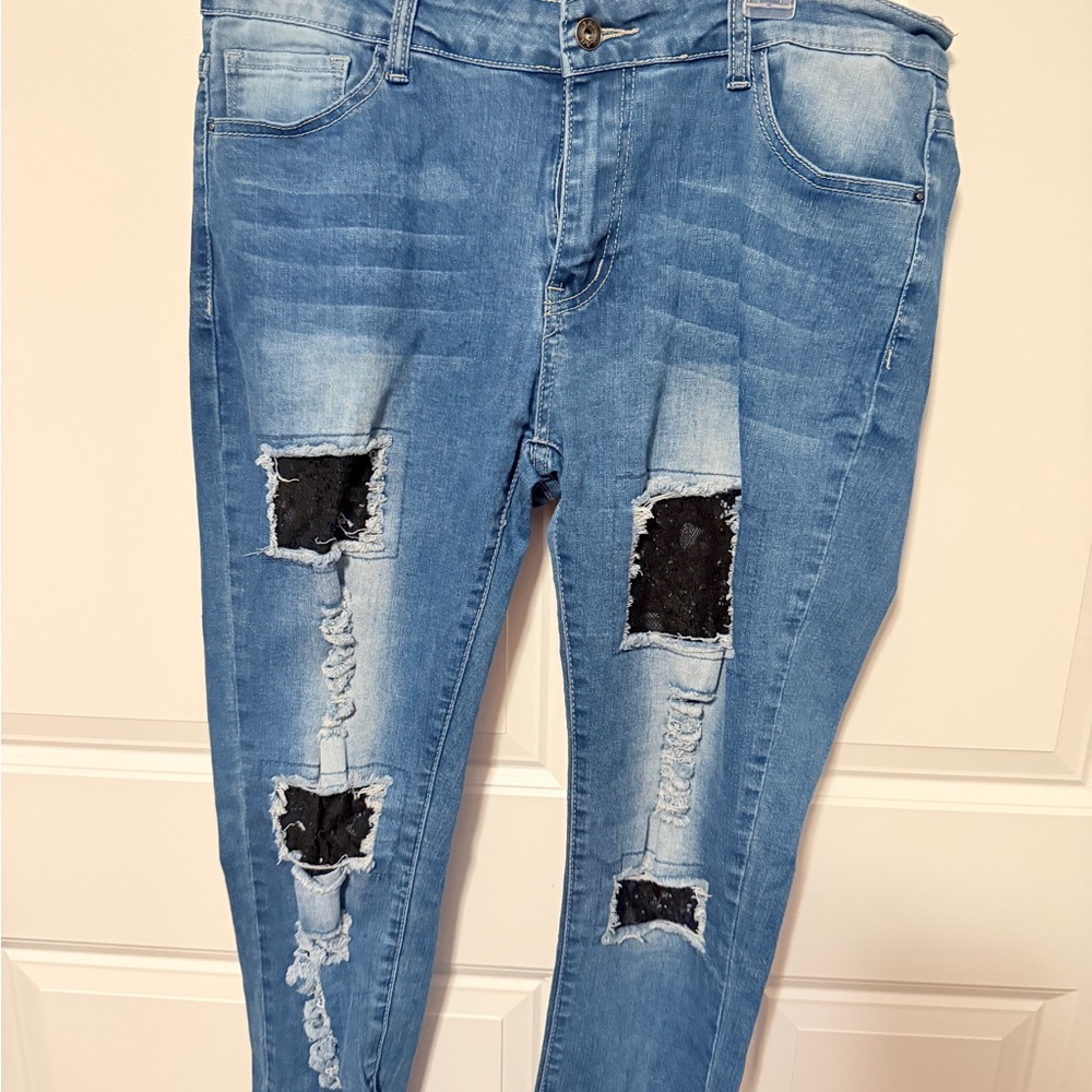 Distressed Light Blue Women’s Jeans with Black Patch Details